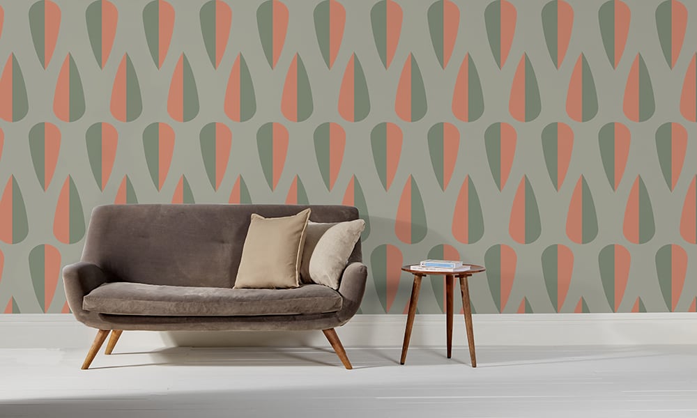 Green and orange large arrow shaped wallpaper design in a living room 