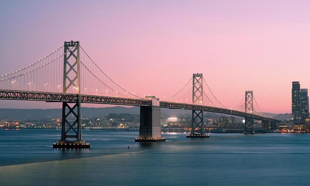 San Francisco at sunset with illumiated Bay Bridge 