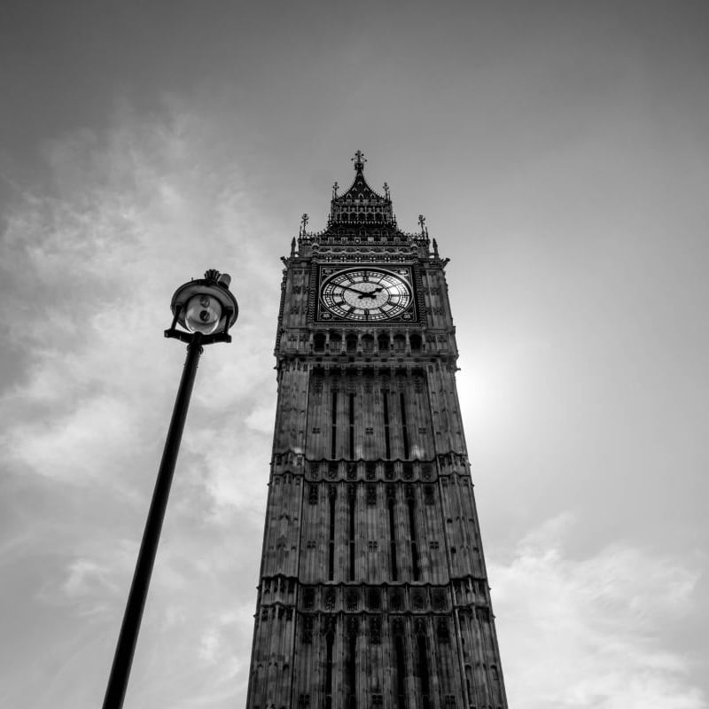 Living with a grey chair with black and white wall mural of Big Ben in London