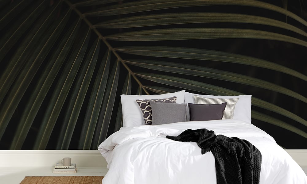 Abstract palm wall mural in dark green and black in a bedroom