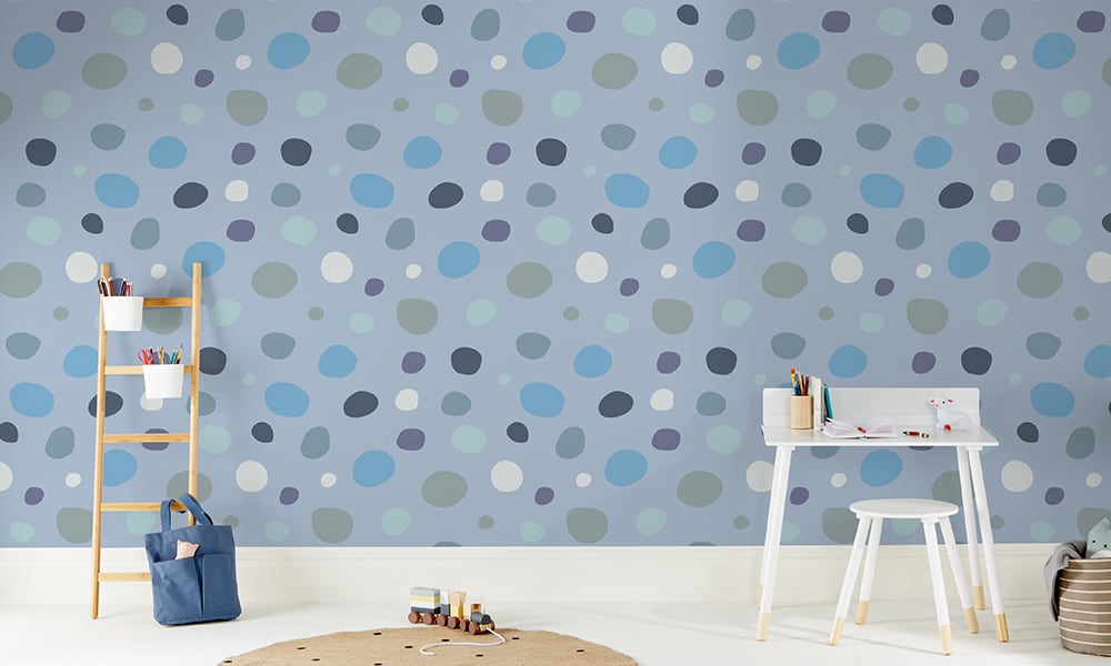 Fun dotty blue wallpaper in a large sized pattern in a kid's bedroom 