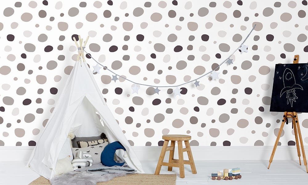 Playful grey spot print wallpaper in a large size pattern in a kid's bedroom