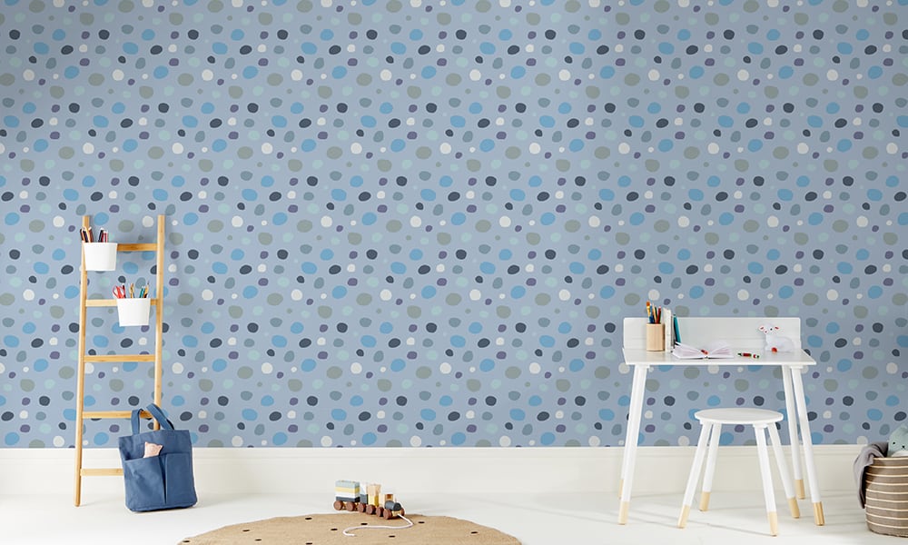 Modern blue spotty wallpaper in a medium sized pattern in a kid's bedroom 
