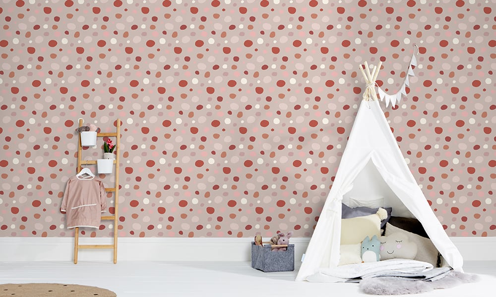 Fun dotty pink wallpaper in a medium sized pattern in a kid's bedroom 
