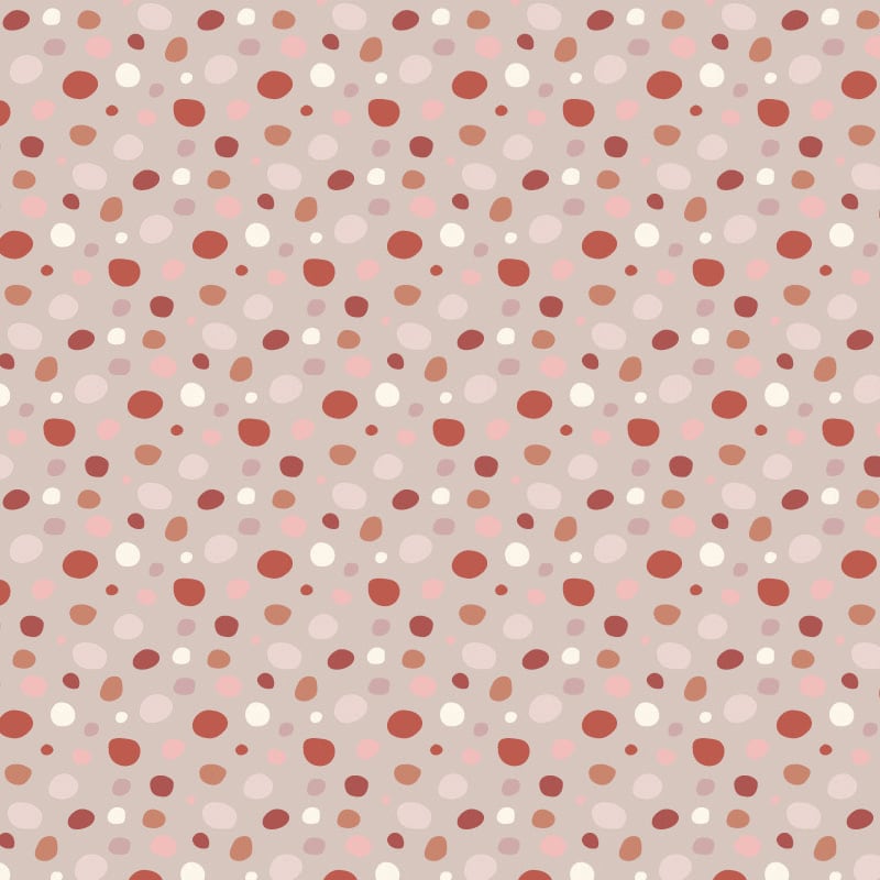 Girlie pink dotty print wallpaper design in warm colour tones in a child's bedroom