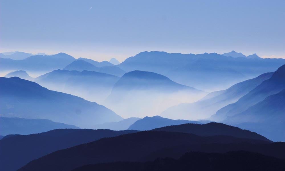 Misty mountain scene in blue colour tones