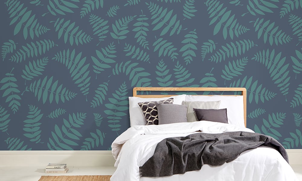 Large-scale leaf design wallpaper in navy blue in a bedroom 