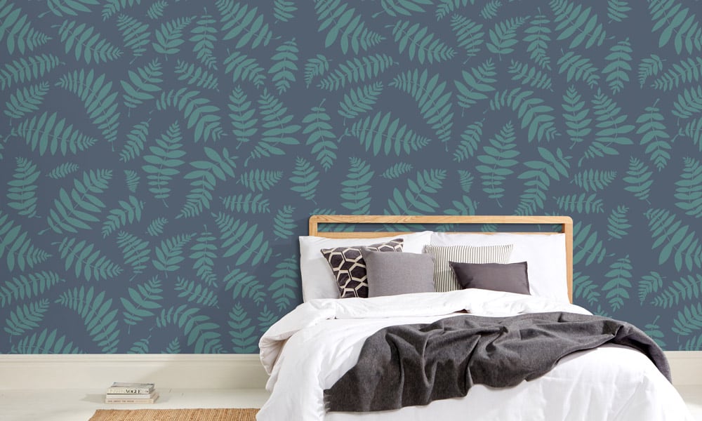 Leafy navy blue wallpaper design in a scandi minimal bedroom 