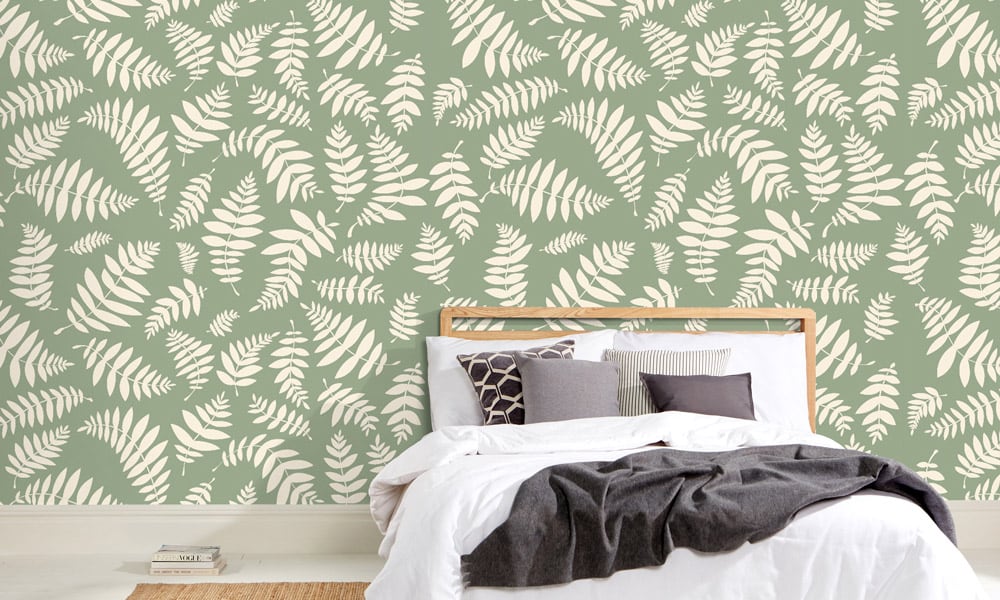 Green bracken wallpaper design in a bedroom setting