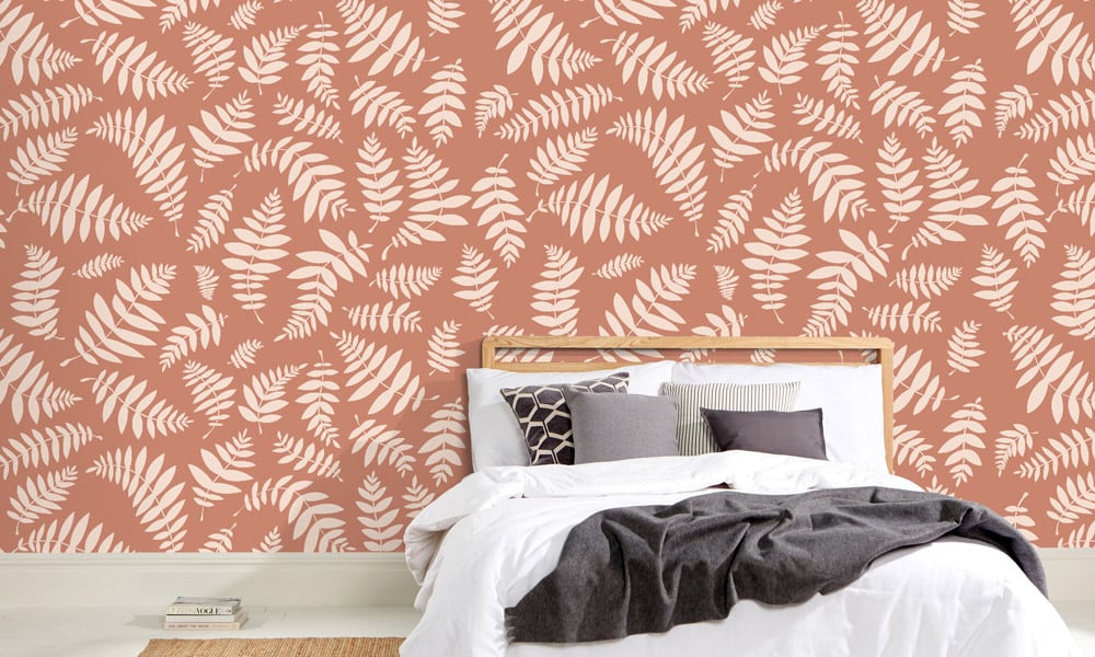 Leaf wallpaper in terracotta orange in a minimalist bedroom 