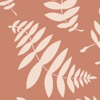 Leafy patterned wallpaper with a terracotta orange background in a scandi bedroom
