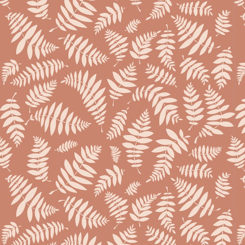 Leafy patterned wallpaper with a terracotta orange background in a scandi bedroom