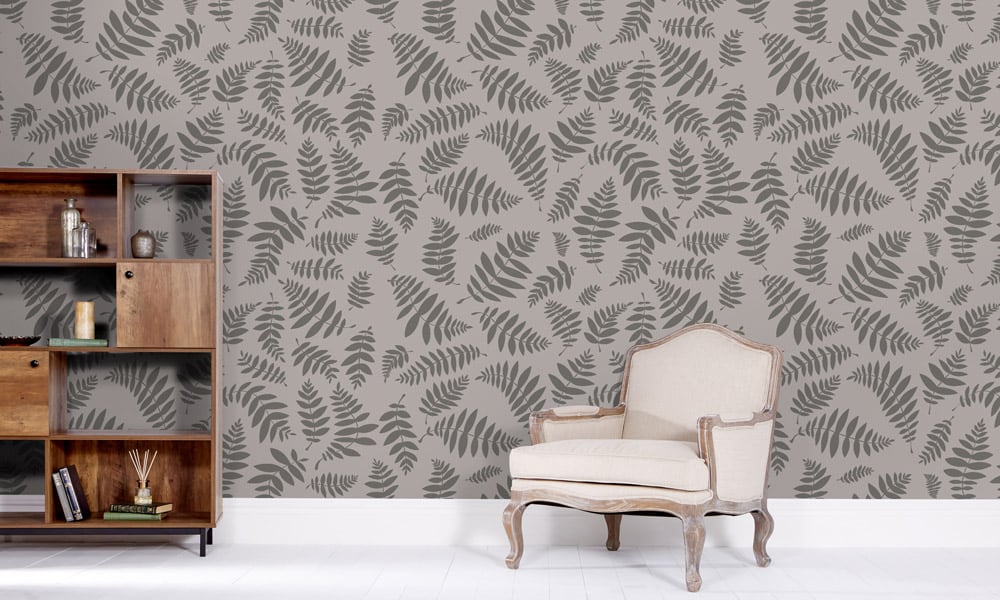 Dark grey leaf print wallpaper in medium-size in a lounge with a bookcase