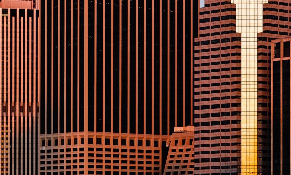City wall mural with skyscraper buildings in orange and black colours