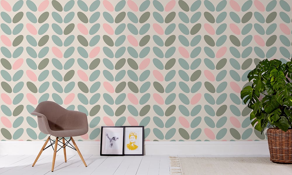 Blue, pink and green pastel coloured wallpaper in a medium-sized pattern with a grey chair