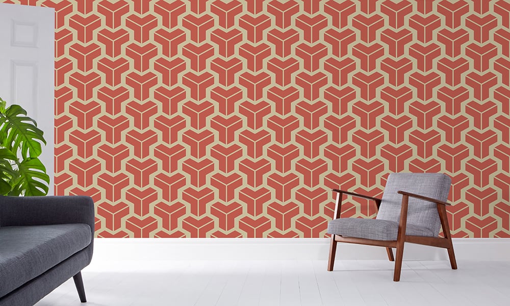 Orange geometric wallpaper design in a medium-sized pattern with a grey chair