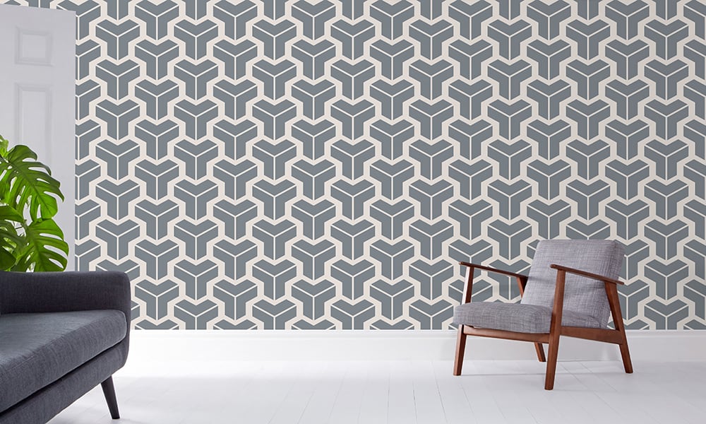 Steel blue-grey geometric wallpaper in a medium-sized pattern in a living room with grey chair