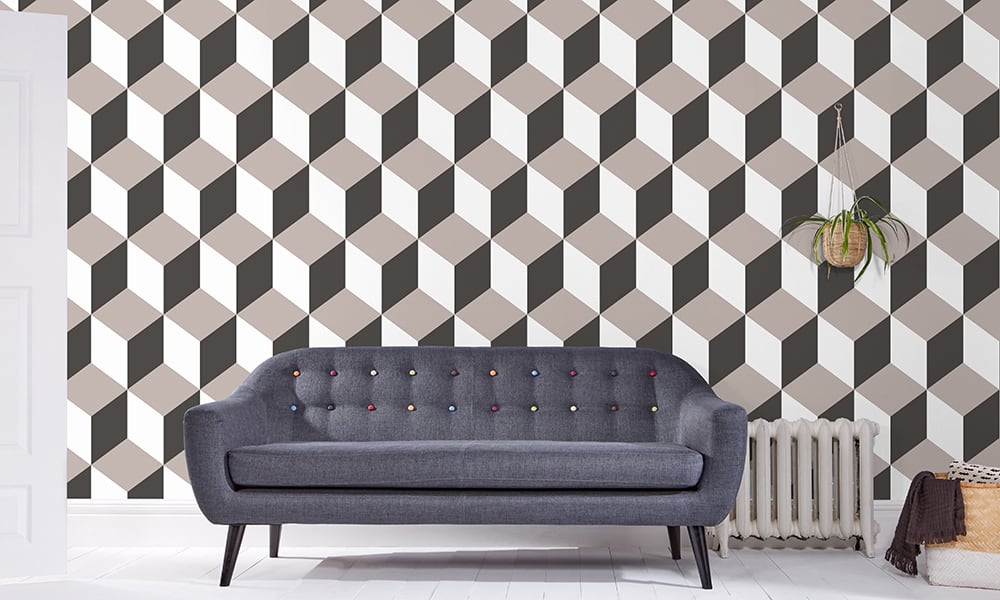 Large scale cube-shaped wallpaper design in grey and white tones in a living room