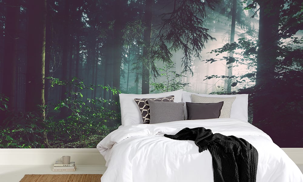 Bedroom setting with forest wall mural