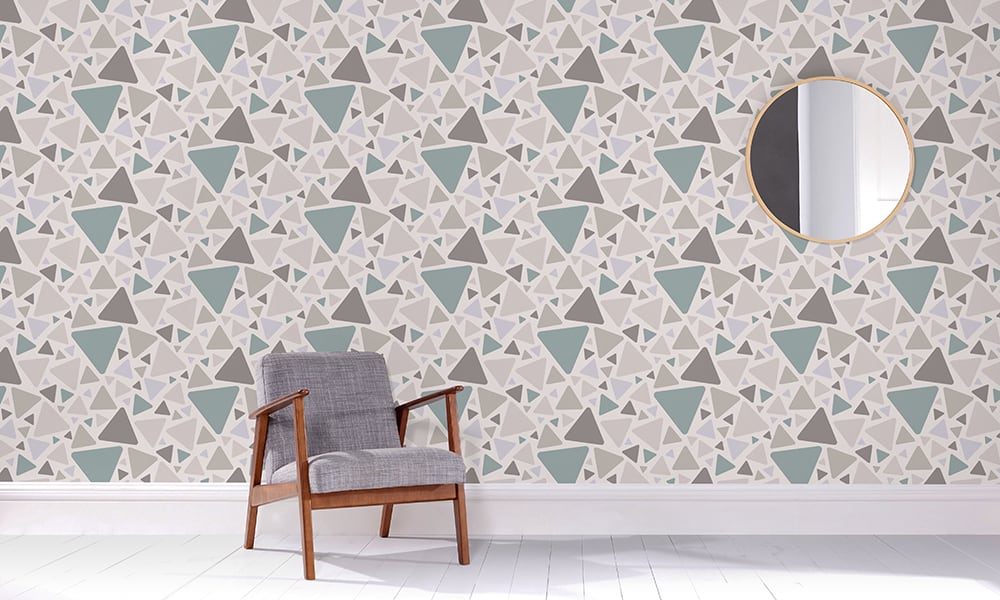 Medium-sized triangular pattern in a teal and grey colour tones in a living room with grey chair