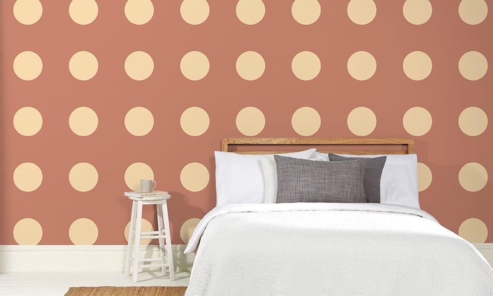 Large-scale dotty pattern in a terracotta colour in a bedroom