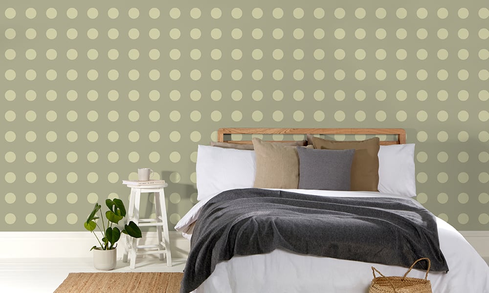 Khaki green polka dot wallpaper in a medium-sized print in a bedroom