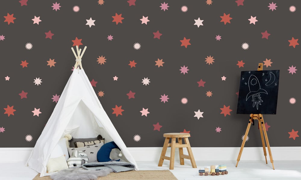 Large-scale star scene wallpaper with red and pink stars in a kid's bedroom