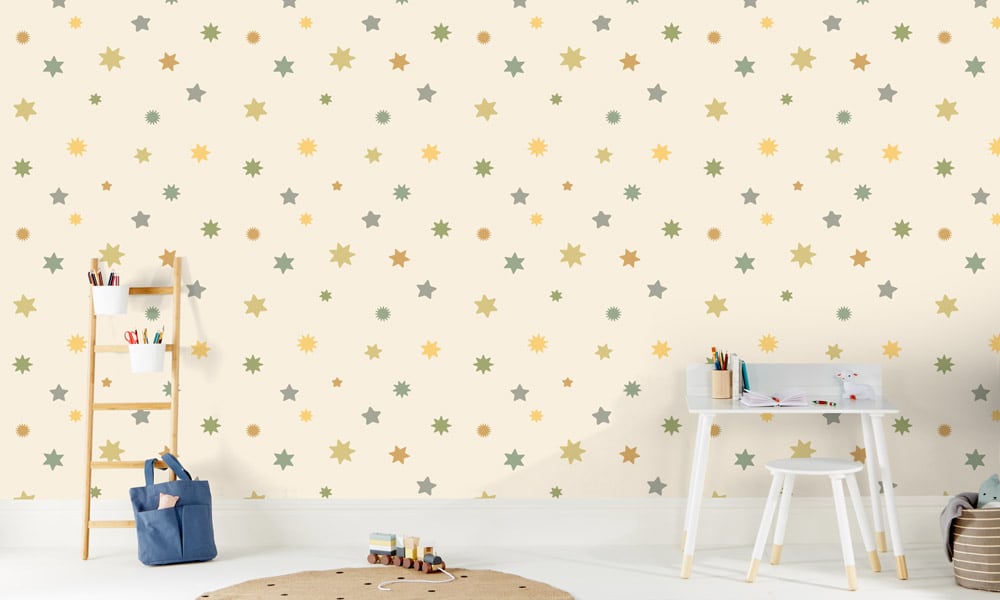 Starry night sky wallpaper with green and yellow stars in a kid's room
