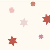 Star wallpaper with a neutral background and pink and red stars in kid's bedroom