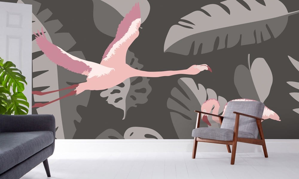 Grey wall mural with leaves and pink flamingos in a living room