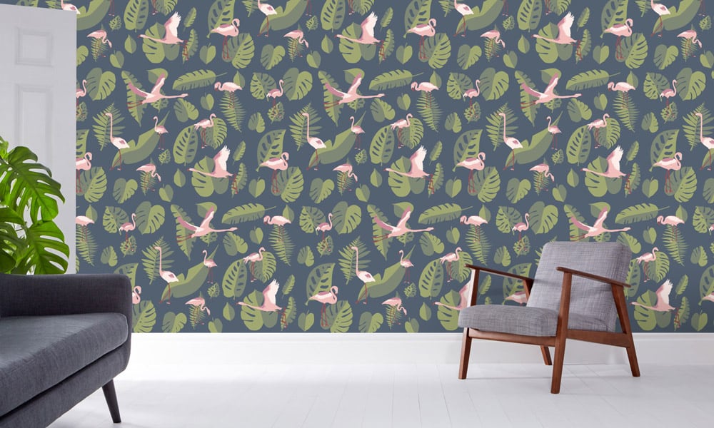 Pink flamingo wallpaper with a navy background and green leaves in a living room