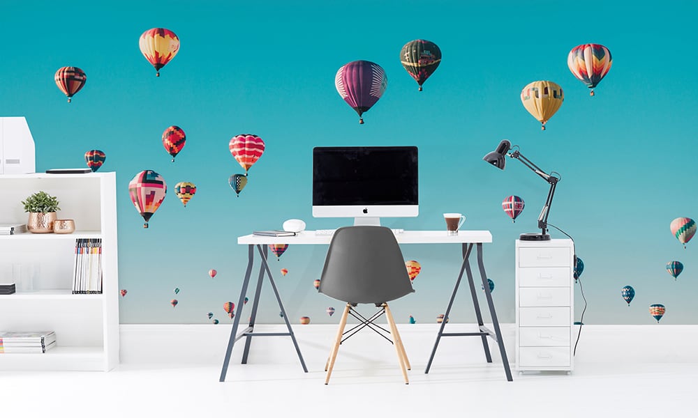 Colourful hot air balloon wall mural with blue sky in an office