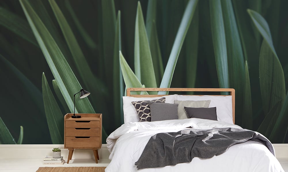 Green wall mural of detailed blades of grass in a modern minimal bedroom