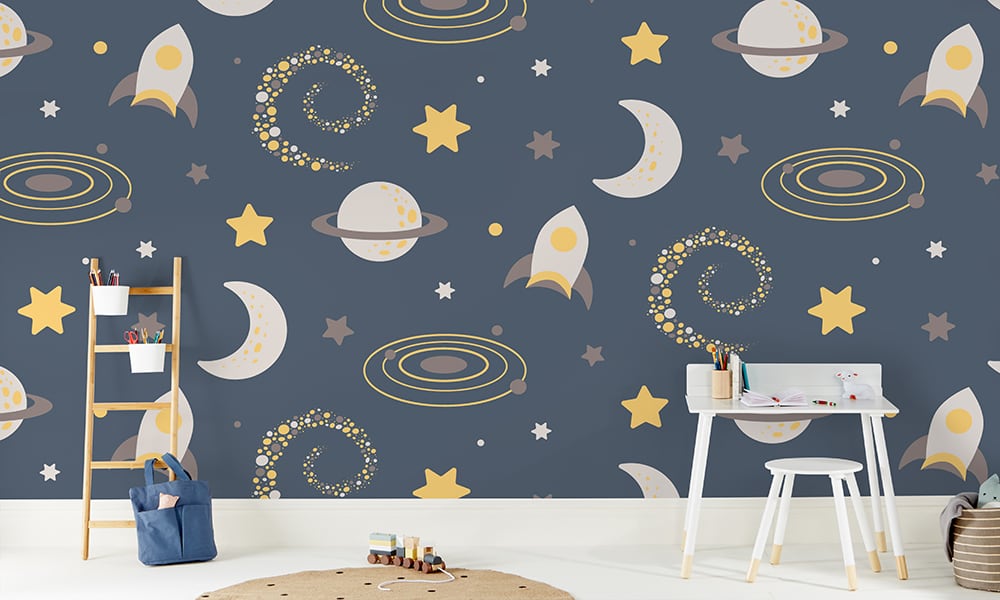 Large-scale galaxy-themed wallpaper with rockets, stars and moons in a kid's bedroom