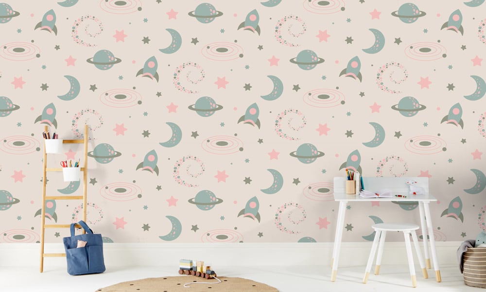 Galaxy wallpaper for a child's bedroom in pastel colours with rockets, stars and moons