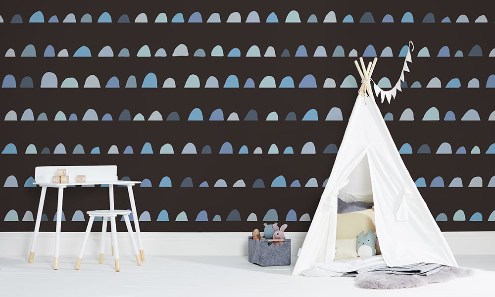 Large-scale patterned wallpaper in blue and black with kid's teepee tent