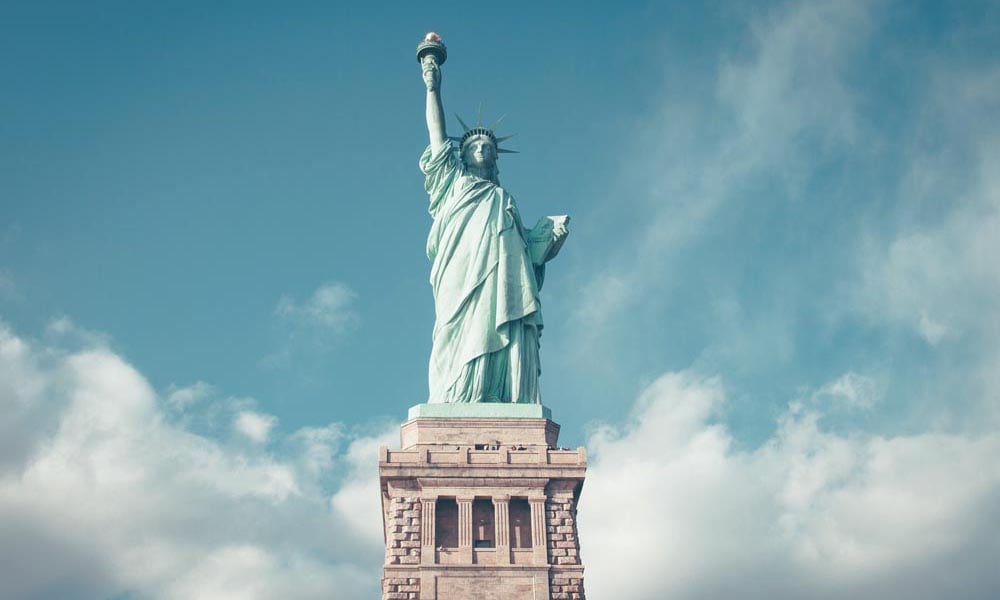New York City's famous Statue of Liberty with blue sky backdrop