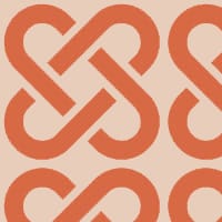 Orange linked patterned wallpaper with grey chair and picture frame