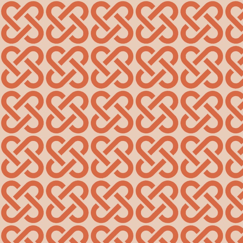 Orange linked patterned wallpaper with grey chair and picture frame