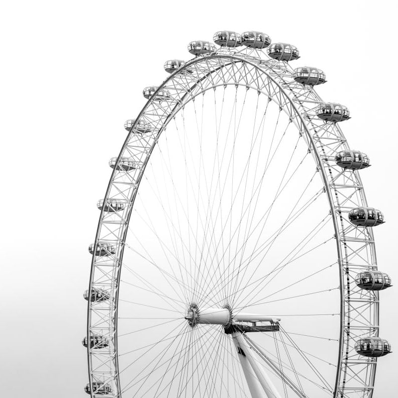 Black and white London eye wallpaper with grey chair and frames