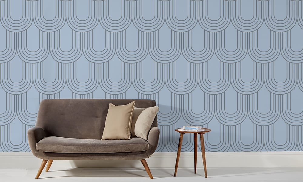 Large-scale blue curve wallpaper pattern in a retro style living room