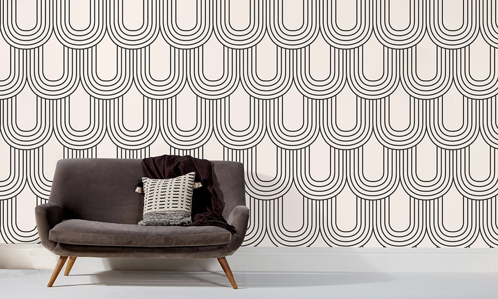 Large-scale black and white arch wallpaper in a mid-century style living room 