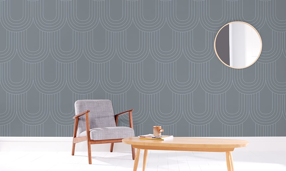 Steel blue wallpaper pattern in a large scale in living room with grey chair
