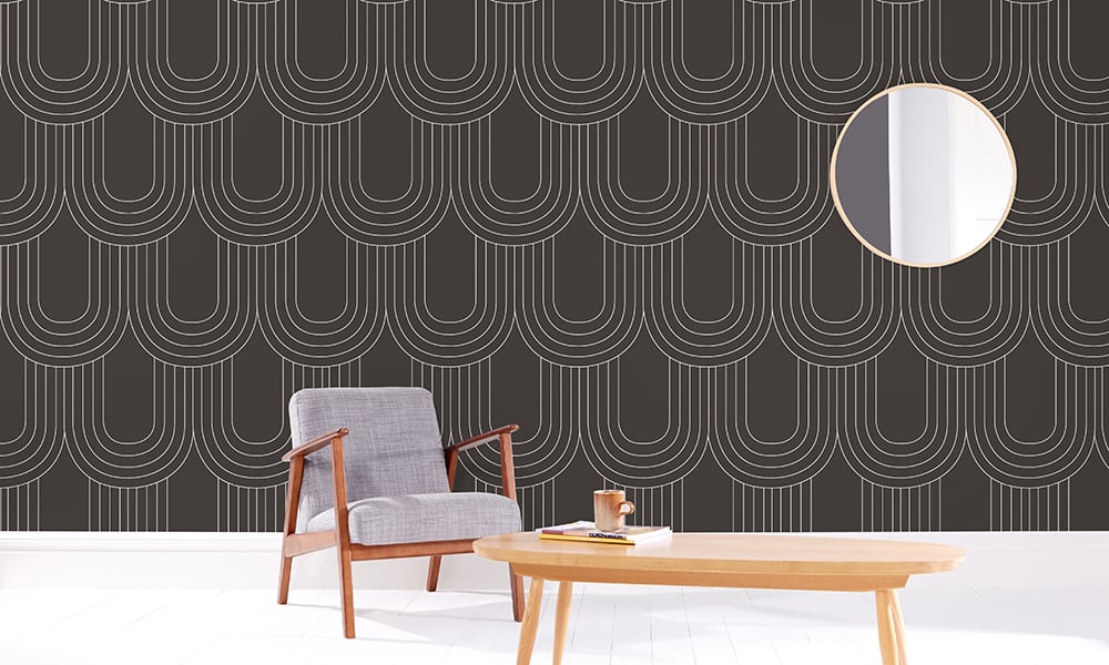 Ink grey wallpaper pattern in a large scale in living room with grey chair