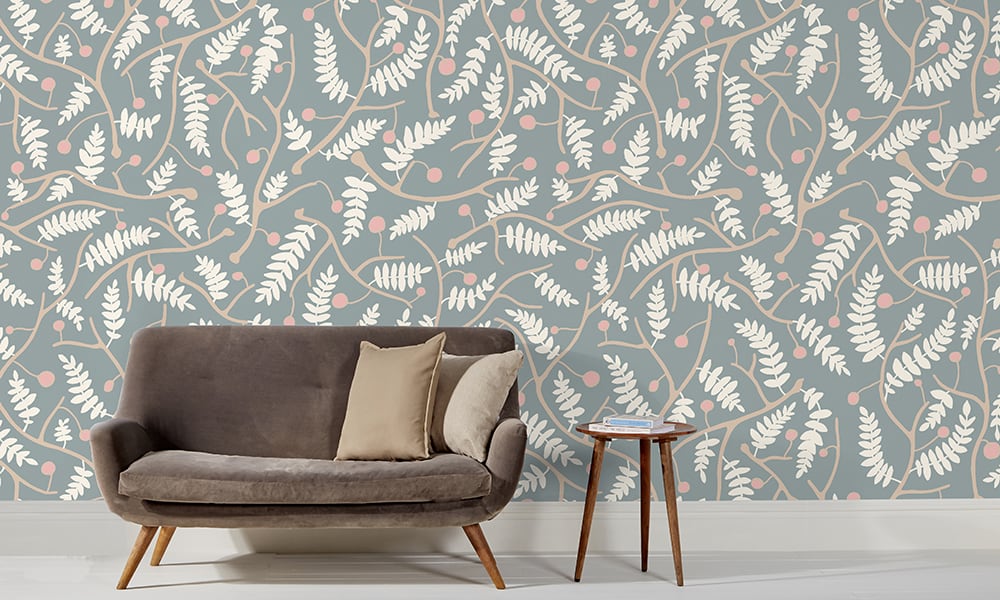 Blue wallpaper in a large scale situated in living room with grey sofa 