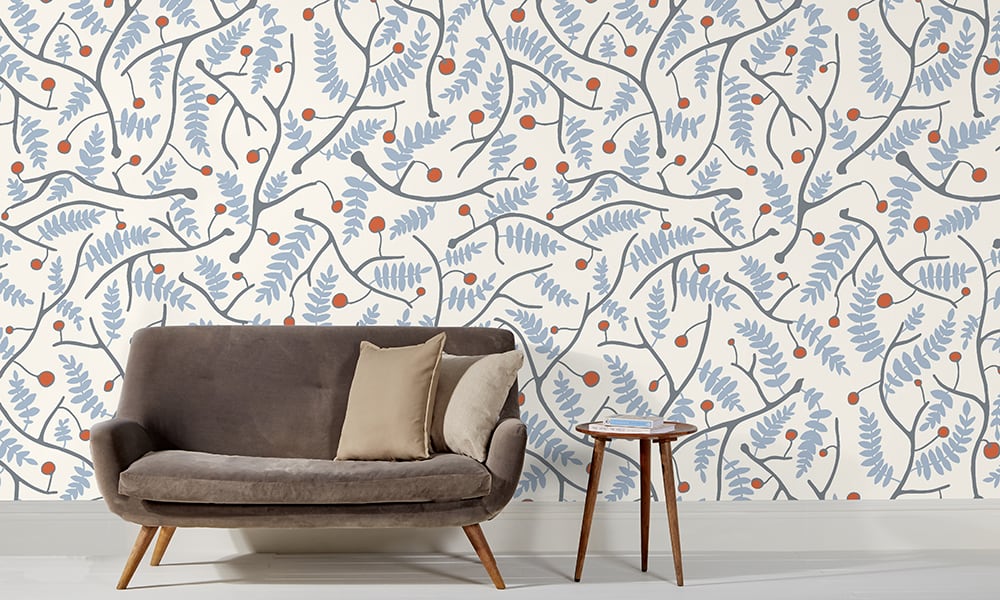 Cool blue wallpaper in a large scale situated in living room with grey sofa 