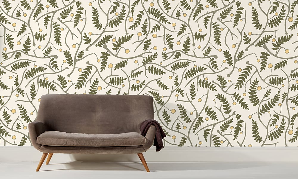 Green wallpaper in a large scale situated in living room with grey sofa 