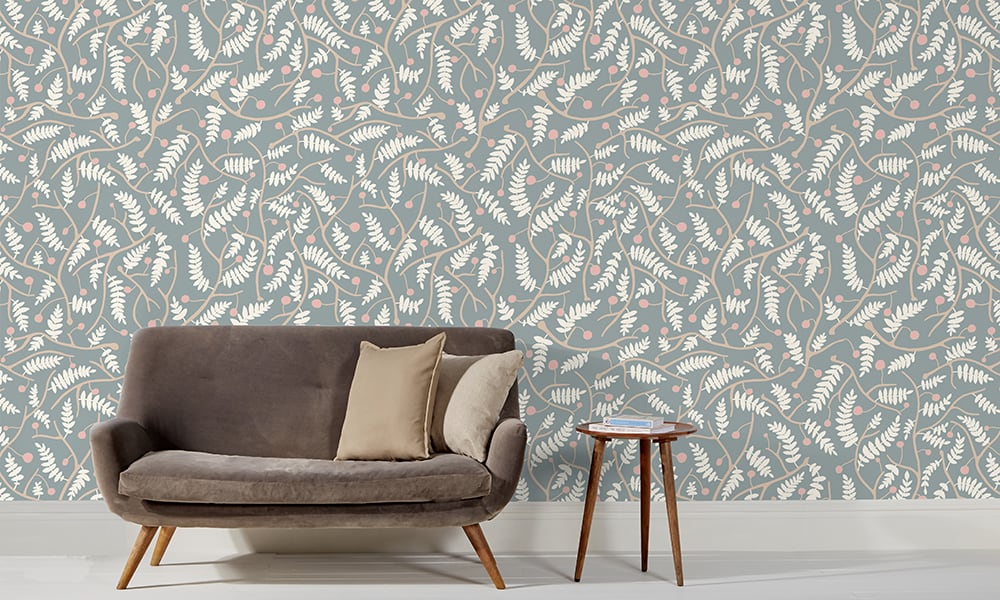 Blue wallpaper in a medium scale situated in living room with grey sofa 