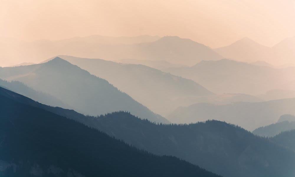 Ombre peachy pink and green mountain landscape