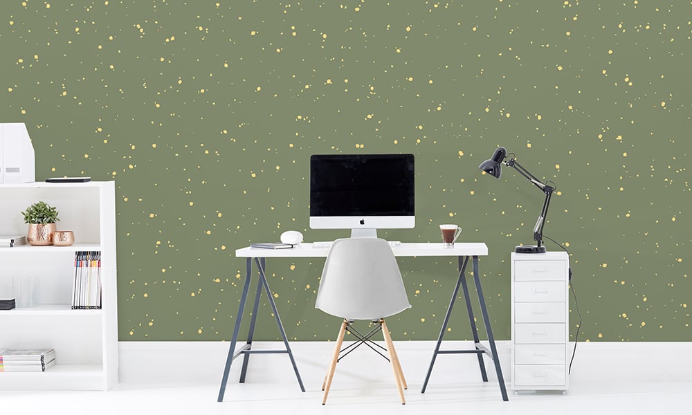 Large scale noise wallpaper pattern in green in office setting with desk